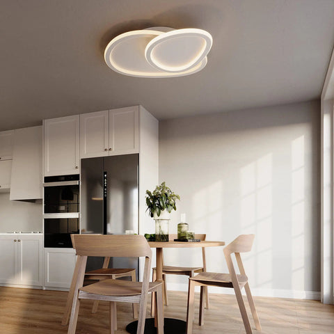 Cloud LED Ceiling Light With Rotatable Edge For Modern Homes in a kitchen above dining table