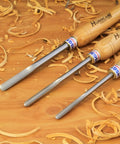 Pro Grade Three Piece Spindle Gouge Set For Woodturning Built Tough For Heavy Duty Cuts With Rock Solid Beech Handles on a wood surface.