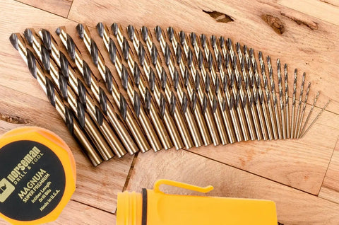 29 Piece Drill Bit Set With 135 Degree Split Point, Jobber Length, Orange And Gold Finish, Sizes 1/16 To 1/2 Inch, laid on wood surface