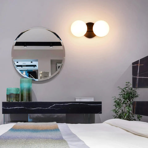 Dope Matte Black Two Light Globe Vanity Wall Sconce with Opal Glass Shades in modern bedroom setup