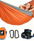 Ultralight Camping Hammock For Hiking And Travel in orange with straps, carabiners, and carrying bag. Ideal for beach, patio, or backpacking trips.