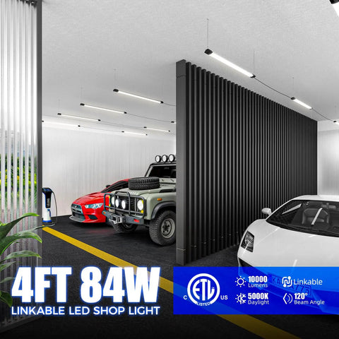 4 Foot LED Shop Lights 84W 10000 Lumens Daylight 5000K Ultra Bright Lit Garage Lighting illuminating a modern garage with vehicles