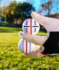 Gloved hand holding golf ball with stencil design, part of 8 Pack Precision Golf Ball Marker Set With 4 Color Marking Stencils And 4 Vibrant Markers