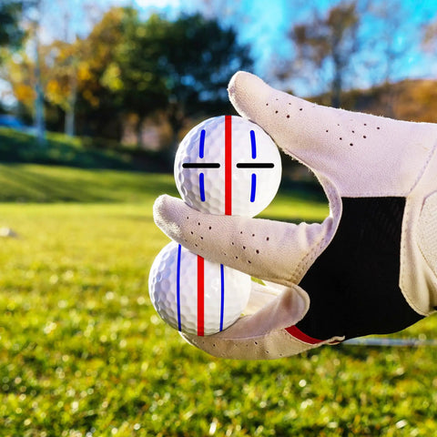Gloved hand holding golf ball with stencil design, part of 8 Pack Precision Golf Ball Marker Set With 4 Color Marking Stencils And 4 Vibrant Markers