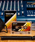 424-S High Bias Cobalt Type II C-60 Blank Studio Cassette Tape for audio recording in a home studio setup with headphones and mixer.