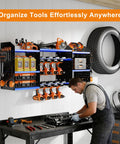 Man working in a garage with 40 Inch Wall Mounted Power Tool Organizer With Charging Station For Cordless Tools installed on wall.