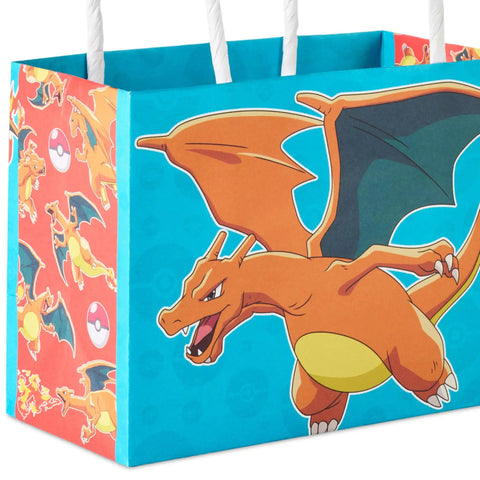 Pokemon Mini Gift Bags 18 Pack With Handles For Birthday Parties And Classroom Treats Featuring Pikachu Charizard Eevee And Gengar Designs About 5 Inches Wide By 4 Inches High By 3 Inches Deep, showing Charizard design on blue and red paper bag.