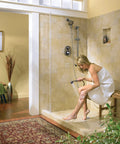Woman using XL Chrome Showerhead With One Function Power Spray, 4.38 Inch Diameter, Half Inch IPS Connection, 2.5 GPM At 80 PSI