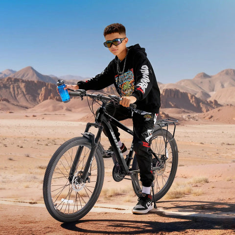 Boy riding 26 Inch Kids Mountain Bike With 21 Speed Drivetrain Front Suspension Fork Dual Disc Brakes in desert.