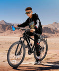 Child riding Kids 24 Inch Mountain Bike With Front Suspension, 21 Speed Drivetrain, Dual Disc Brakes, in desert landscape