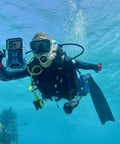 Diver using Dive 2.0 Waterproof iPhone Housing Delivers 130 Feet Depth Ultra Tough Underwater Case snorkeling with coral reef view