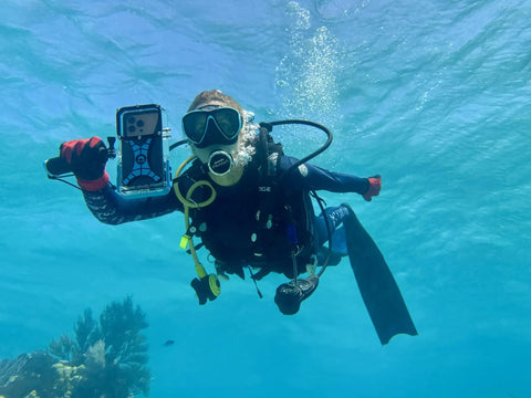 Diver using Dive 2.0 Waterproof iPhone Housing Delivers 130 Feet Depth Ultra Tough Underwater Case snorkeling with coral reef view