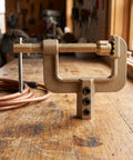 Heavy Duty Ground Clamp For Welders With High Current Transfer And Thickened Copper Contact Design To Stop Rust and strong brass construction on a wooden workbench.
