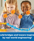 Children playing with STEM Explorers Bridge Builders Classroom Set, constructing colorful suspension bridge model.