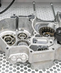 Close-up of metal machinery parts and bearings inside a cabinet, showing the internal structure and components in detail.