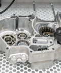 Aluminum engine part undergoing sandblasting with tool; suitable for Aluminum Oxide Fine Sand Blasting Media 19 Pounds For Cabinets And Guns Hard Sharp Grit For Metal And Glass Surface Prep Long Lasting Reusable Abrasive With No Detectable Crystalline Silica application.