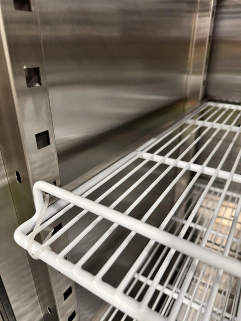 Heavy Hitter Commercial Merchandiser Freezer With Three Self Closing Glass Doors and Bulletproof Adjustable Shelving close-up of steel rack