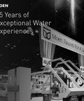Moen exhibition booth with '85 Years of Exceptional Water Experiences' slogan at a trade show, showcasing faucet models