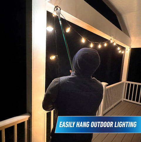 Person using 36 inch reacher grabber tool to hang outdoor lights on porch at night