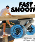 Kicktail Cruiser Longboard wheels close-up with blue finish and bamboo deck, man riding for commuting and carving.