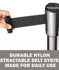 Hand extending silver belt of Stanchions Set Of 2 36 Inch Height With Six Point Five Foot Retractable Belt Heavy Duty Workhorse Steel Crowd Control Barriers Black Powder Coated Posts Silver Belts For Event Safety And Restaurant Queue Management