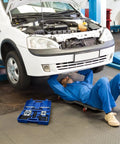 Professional Grade 14 Piece Automotive Bearing Puller Kit With Dual Disc Separator Aid To Remove Bearings Safely For Cars Or Motorcycles Great For Wrenching Fans Who Want Fast Results Using A Killer Puller Kit For Trucks And Bikes. blue case open beside mechanic under white car