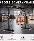 3 Ton Portable Gantry Crane With 8.53 Ft Wide Span And 8.53 To 12.47 Ft Adjustable Height Manual Trolley Lift System For Auto Shops Factories And Garages Heavy Duty Steel Construction Black lifting a wooden crate in a warehouse setting.