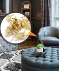 Slick Daisies Antique Gold Upholstery Tacks and 100 Piece Bronze Flat Head Nails with Rust Proof Finish displayed in a living room setting.