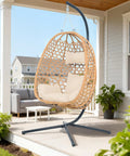 Cozy Hanging Egg Chair With Stand And Plush Cushions for patio, natural wood finish, modern boho style, rattan swing seat.