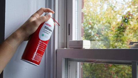 Person using Silicone Lubricant With Teflon Fluoro Polymer For Non Metal Materials on window frame to prevent sticking