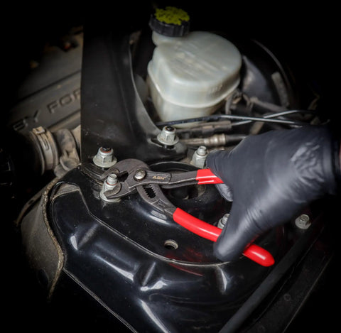 Person using Beefy 3 Piece Slip Joint Pliers Set Alligator Pliers 7in 10in 16in for Plumbing Auto and Heating on car engine bolt.