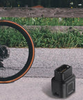 USB-C To 4-Pin Charger Adapter For 12-Speed Electronic Derailleurs And Type-C Converter Cable next to bike wheel