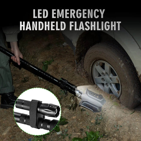 28-In-1 Survival Shovel Set With Axe And Knife used to dig beside a car tire at night, illuminated by LED flashlight
