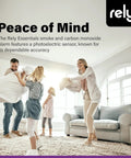 Family playing in living room, advertisement for 5600 Smoke And Carbon Monoxide Alarm With Hardwired Power And Battery Backup.