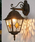 Outdoor vintage-style lantern with stained glass, mounted on wall, A19 LED Dusk To Dawn Filament Bulb For Outdoor Use lighting scene