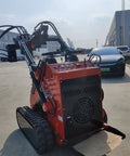 Mini Skid Steer Loader 1800 Lb Capacity With Auger on paved area, showing control panel and tracks for compact construction use.
