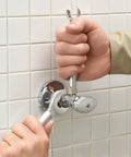 One Stop 2-In-1 Wrench For Angle Stops And Compression Couplings With Dual Wrench Design used on a silver valve in tight space