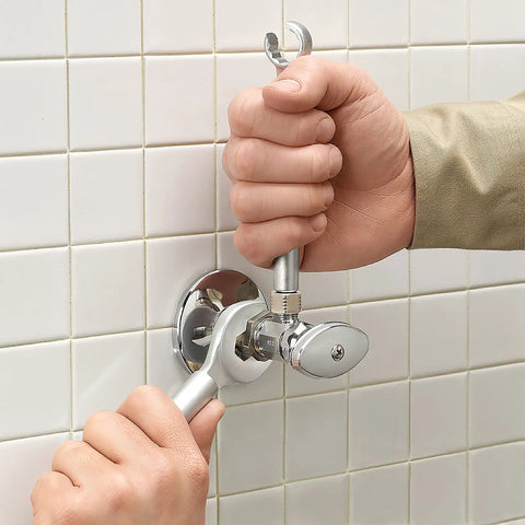 One Stop 2-In-1 Wrench For Angle Stops And Compression Couplings With Dual Wrench Design used on a silver valve in tight space