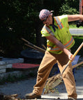 Outdoor worker wearing Original MiraCool 940 Cooling Neck Bandana in assorted colors, shoveling, suitable for heat relief during hustle sports.