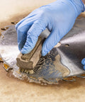 Gloved hand cleaning saw blade using Blade And Bit Cleaner For Tools 18 Fl Oz Resin Pitch And Rust Remover Safe Non Toxic Formula For Workshop Tools Keeps Surfaces Clean Without Harsh Scrubbing.