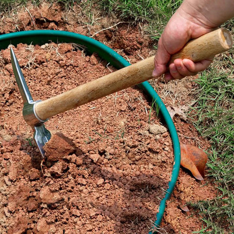 Using Heavy Duty Garden Pick Axe With Wooden Handle And Stainless Steel Mattock to break dense clay soil in garden.