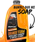 Orange bottle of car wash soap, labeled "Orange Foam Super Soapy Shampoo & Surface Cleaner," with suds and "Bundle Our New Soap" text.