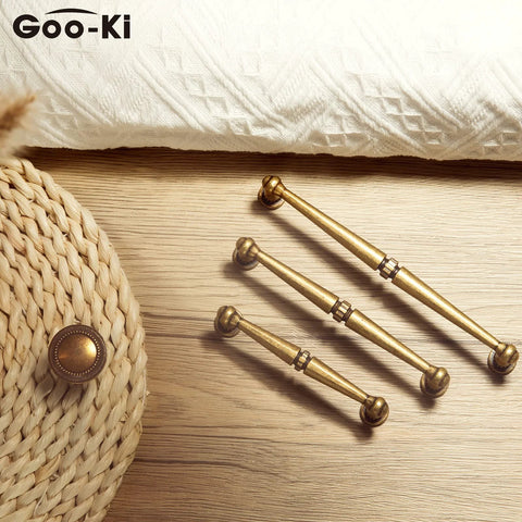 6 Pack Antique Brass Cabinet Handles Zinc Alloy Drawer Pulls For Kitchen And Furniture on a wooden surface, classic rustic hardware.