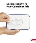 Clear Coffee Scoop For POP Storage Containers, 2 Tbsp 30 mL Capacity, fits under lid held by hands showing attachment.