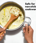 Wooden Corner Spoon And Scraper For Nonstick Cookware Beechwood With Natural Oil Finish and soup being stirred in a pot