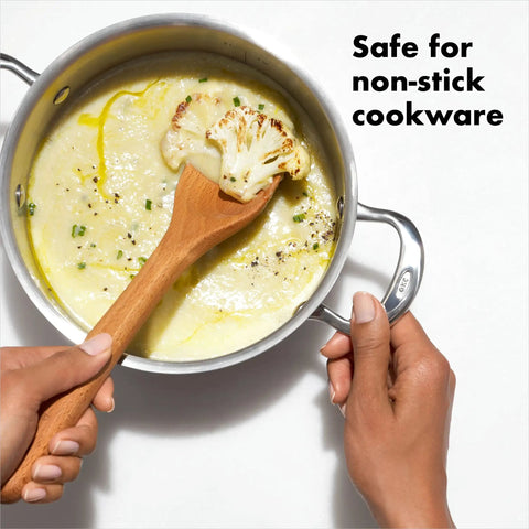 Wooden Corner Spoon And Scraper For Nonstick Cookware Beechwood With Natural Oil Finish and soup being stirred in a pot