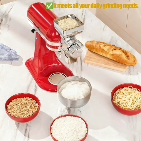 Grain mill attachment for KitchenAid stand mixer; red all-metal construction mounted; bowls of flour, grains, pasta.