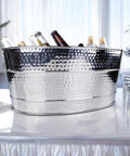Aspen Heavy-Duty Oval Stainless Steel Drink Cooler For Parties 25-Quart Large Ice Bucket with bottles on a table