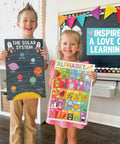Children holding Laminated Preschool Poster Set For Toddlers And Kindergartners 16 Colorful Educational Posters in a classroom.