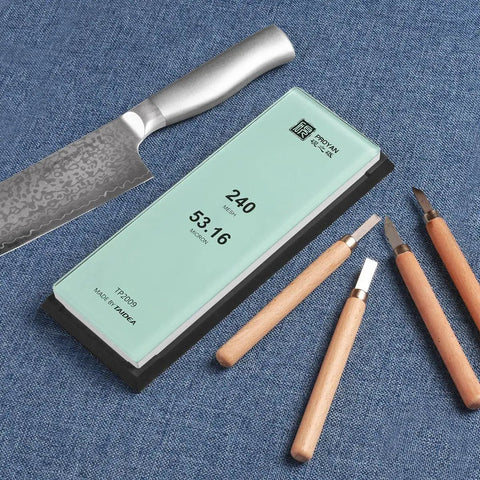 Professional Glass Sharpening Stone Whetstone 15,000 Grit For Razor Sharp Knives displayed with tools on fabric surface